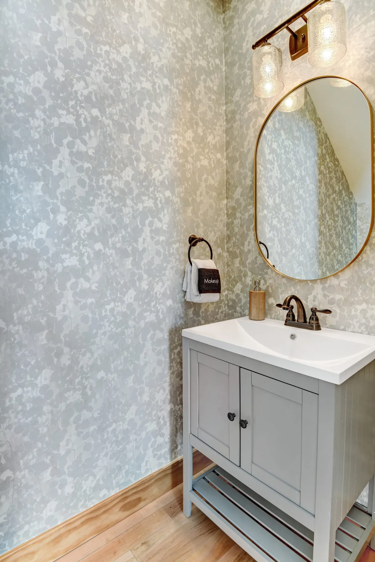 A serene, modern bathroom vanity area with elegant lighting and a mirror, suggesting a private space for personal care and relaxation.